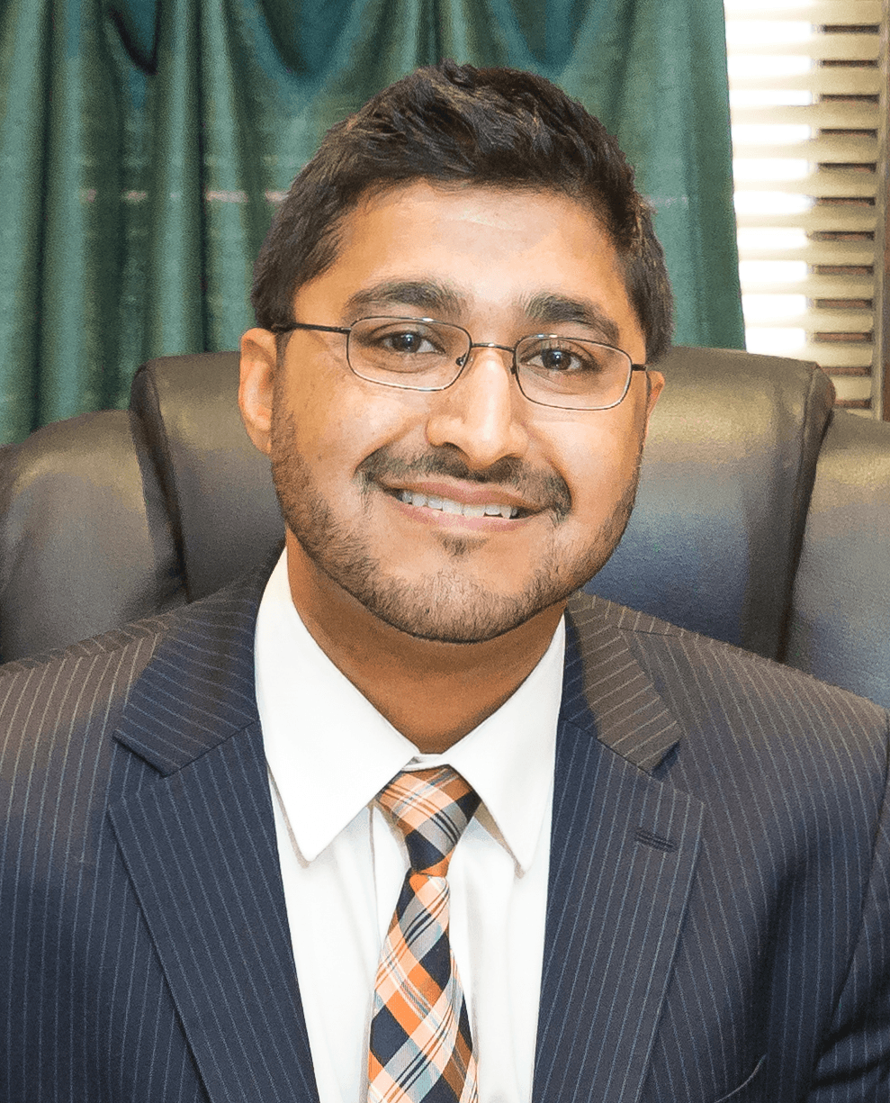 Saif H. Rahman, criminal defense attorney, in a pinstripe suit and glasses